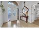Inviting entryway with a decorative glass door, tiled floor, large mirror, and stylish chandelier at 10640 Parkway Dr, Clermont, FL 34711