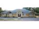 Charming single-story home with a well-manicured lawn and attractive front door at 10640 Parkway Dr, Clermont, FL 34711