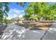 Picturesque one-story home with mature trees, an ample driveway, and a lush, well-manicured lawn at 10640 Parkway Dr, Clermont, FL 34711