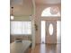 Bright foyer with high ceilings, arched window, and tile floors at 10640 Parkway Dr, Clermont, FL 34711