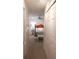 Hallway view of a well-lit bedroom with neutral walls and carpet at 10640 Parkway Dr, Clermont, FL 34711