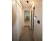 Hallway with neutral walls, carpet flooring and white trim leading to the kitchen at 10640 Parkway Dr, Clermont, FL 34711