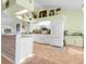 Bright kitchen features white cabinets, a central island, tile floors, and stainless steel appliances at 10640 Parkway Dr, Clermont, FL 34711