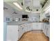 Bright kitchen features white cabinets, tile floors, and stainless steel appliances at 10640 Parkway Dr, Clermont, FL 34711