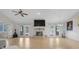 Spacious living room boasts a fireplace, tile flooring, ceiling fan, and French doors leading to the backyard at 10640 Parkway Dr, Clermont, FL 34711