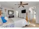 Spacious main bedroom with a ceiling fan, large window, and decorative wall art at 10640 Parkway Dr, Clermont, FL 34711