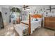 Spacious main bedroom with a ceiling fan, large window, and decorative wall art at 10640 Parkway Dr, Clermont, FL 34711