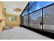 Enclosed patio featuring screened windows, ceiling fan, and neutral flooring at 10640 Parkway Dr, Clermont, FL 34711