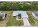 Aerial view of a well-manicured single-Gathering home with lush landscaping and a private driveway at 10683 Se 174Th Loop, Summerfield, FL 34491