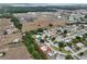 Aerial view of a Spruce Creek home with nearby commercial area and easy highway access at 10683 Se 174Th Loop, Summerfield, FL 34491