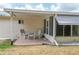 Inviting covered back patio with seating area, perfect for outdoor entertaining and relaxing at 10683 Se 174Th Loop, Summerfield, FL 34491