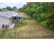 Fenced backyard featuring a covered patio with a seating area, offering a relaxing outdoor space at 10683 Se 174Th Loop, Summerfield, FL 34491