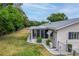Landscaped backyard with a screened-in porch, providing a serene outdoor living space at 10683 Se 174Th Loop, Summerfield, FL 34491