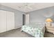 Comfortable bedroom with carpet, a ceiling fan, closet, and neutral walls with a calm atmosphere at 10683 Se 174Th Loop, Summerfield, FL 34491