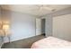 Cozy bedroom with neutral walls, carpet, ceiling fan, and double door closet for ample storage space at 10683 Se 174Th Loop, Summerfield, FL 34491