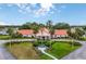 Spacious Spruce Creek clubhouse with lush landscaping, an American flag, and a welcoming entrance at 10683 Se 174Th Loop, Summerfield, FL 34491