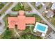 Aerial view of a community clubhouse with a swimming pool and well-manicured grounds at 10683 Se 174Th Loop, Summerfield, FL 34491
