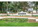 Well-maintained Spruce Creek entrance sign with vibrant landscaping and welcoming design at 10683 Se 174Th Loop, Summerfield, FL 34491