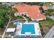 Community pool with lounge chairs, a jacuzzi, and a shaded bar in a well-maintained area at 10683 Se 174Th Loop, Summerfield, FL 34491