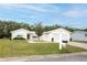 Inviting single-story home with a well-manicured lawn, two-car garage, and neatly placed mailbox at 10683 Se 174Th Loop, Summerfield, FL 34491