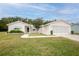 Charming single-story home featuring a two-car garage, well-maintained lawn, and mature landscaping at 10683 Se 174Th Loop, Summerfield, FL 34491