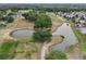 Aerial view of a community golf course with ponds and lush green spaces at 10683 Se 174Th Loop, Summerfield, FL 34491