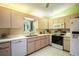 Functional kitchen with white appliances, ample cabinet space, and tile flooring at 10683 Se 174Th Loop, Summerfield, FL 34491