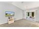Cozy living room with a view to the lanai, neutral paint, and plush carpeting at 10683 Se 174Th Loop, Summerfield, FL 34491