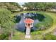 Scenic pond in Spruce Creek with a gazebo, fountain, and natural surroundings at 10683 Se 174Th Loop, Summerfield, FL 34491