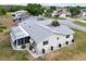 Well-maintained home exterior featuring a fenced backyard, screened porch, and mature landscaping at 10683 Se 174Th Loop, Summerfield, FL 34491