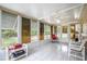 Bright, airy sunroom with tiled floor, ceiling fan, and large windows overlooking the backyard at 10683 Se 174Th Loop, Summerfield, FL 34491