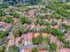 Aerial shot of the property featuring a tile roof, surrounded by lush greenery, offering a serene environment at 1164 E Winged Foot Cir, Winter Springs, FL 32708