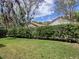 Home exterior showcasing a lush, green backyard with mature trees and a well-manicured lawn at 1164 E Winged Foot Cir, Winter Springs, FL 32708