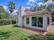 Backyard view of home with a well-maintained lawn and screened patio enclosure at 1164 E Winged Foot Cir, Winter Springs, FL 32708