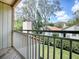 Balcony showcasing a view to the surrounding buildings, lawn, and mature shade trees at 1164 E Winged Foot Cir, Winter Springs, FL 32708