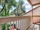Balcony with wooden railings overlooking lush greenery, offering a serene outdoor space at 1164 E Winged Foot Cir, Winter Springs, FL 32708