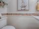 Tastefully updated half bath featuring tile accents, modern toilet, and stylish decor at 1164 E Winged Foot Cir, Winter Springs, FL 32708