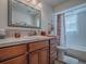 Bathroom vanity featuring wood cabinets, a large mirror and a shower with curtain at 1164 E Winged Foot Cir, Winter Springs, FL 32708