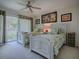 This bright bedroom features twin beds, a ceiling fan, and sliding glass doors to the patio at 1164 E Winged Foot Cir, Winter Springs, FL 32708