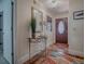 Welcoming entryway with stylish decor, wood floors, and a view to the front door at 1164 E Winged Foot Cir, Winter Springs, FL 32708