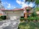 Charming two-story home featuring a Spanish tile roof, two-car garage, second story balcony and manicured landscaping at 1164 E Winged Foot Cir, Winter Springs, FL 32708