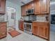 Classic kitchen boasts wood cabinets, stainless steel appliances, tile backsplash, and granite countertops at 1164 E Winged Foot Cir, Winter Springs, FL 32708