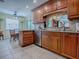 Bright kitchen features wood cabinets, stainless steel dishwasher, granite counters, and tiled backsplash at 1164 E Winged Foot Cir, Winter Springs, FL 32708