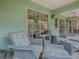 Covered lanai featuring comfortable outdoor seating and views of the lush landscape at 1164 E Winged Foot Cir, Winter Springs, FL 32708