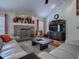 Cozy living room featuring a stone fireplace, modern furnishings, and wood flooring at 1164 E Winged Foot Cir, Winter Springs, FL 32708