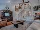 Cozy living room with a ceiling fan, decorative railing, wooden staircase, and large windows at 1164 E Winged Foot Cir, Winter Springs, FL 32708