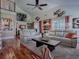 Bright living room boasts high ceilings, modern ceiling fan, wood floors, and an open floor plan at 1164 E Winged Foot Cir, Winter Springs, FL 32708