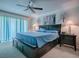 Spacious primary bedroom featuring a ceiling fan, soft lighting, and an ensuite bathroom at 1164 E Winged Foot Cir, Winter Springs, FL 32708