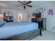 Spacious main bedroom showcases a ceiling fan, dark wood dresser, and ensuite bath at 1164 E Winged Foot Cir, Winter Springs, FL 32708
