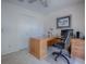 This home office features a wood desk, a comfortable rolling chair, and a ceiling fan at 1164 E Winged Foot Cir, Winter Springs, FL 32708